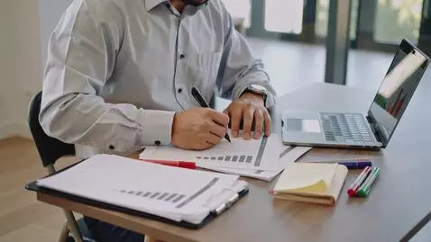 AI Video from prompt: A professional coach-instructor sits at a clean 