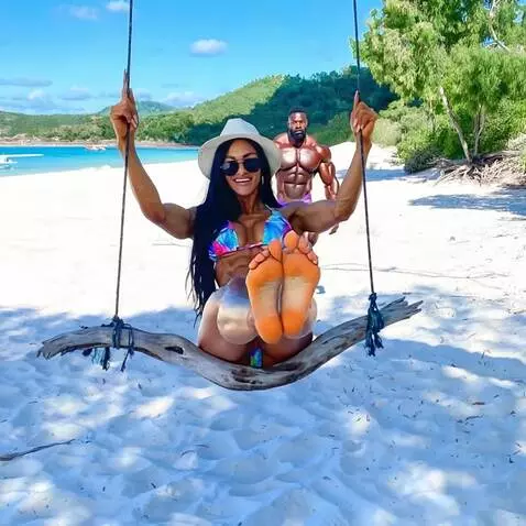 AI Video from prompt: She swings on a swing, laughing, and lifts her l