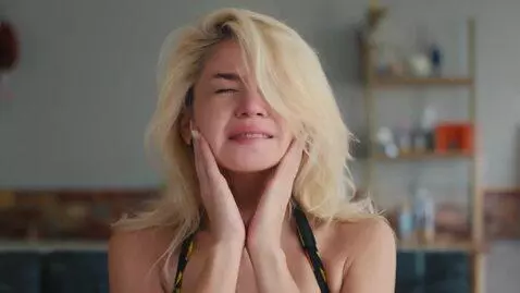 AI Video from prompt: A hot blond tears her bikini