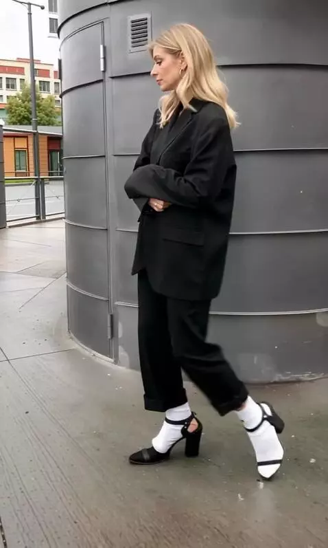 AI Video from prompt: A young woman wearing a jacket, trousers, white 