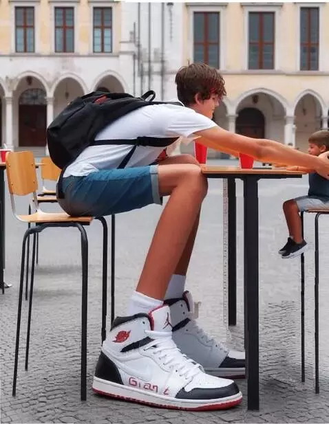 AI Video from prompt: the tall boy takes He takes the little boy sitti