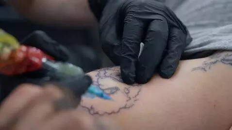 AI Video from prompt: How do cells react to tattoo ink after it enters