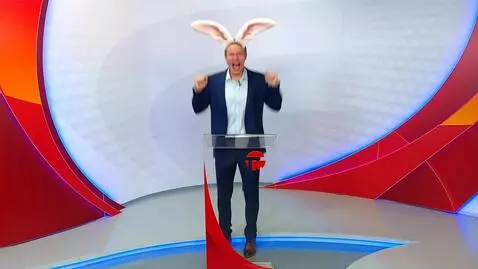 AI Video from prompt: a man in a blue suit grows rabbit ears and jumps