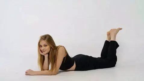 AI Video from prompt: A serene blonde is lying on a snow-white surface