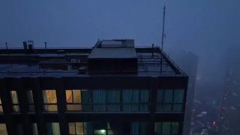 AI Video from prompt: night, rooftops of high-rise buildings, dim ligh