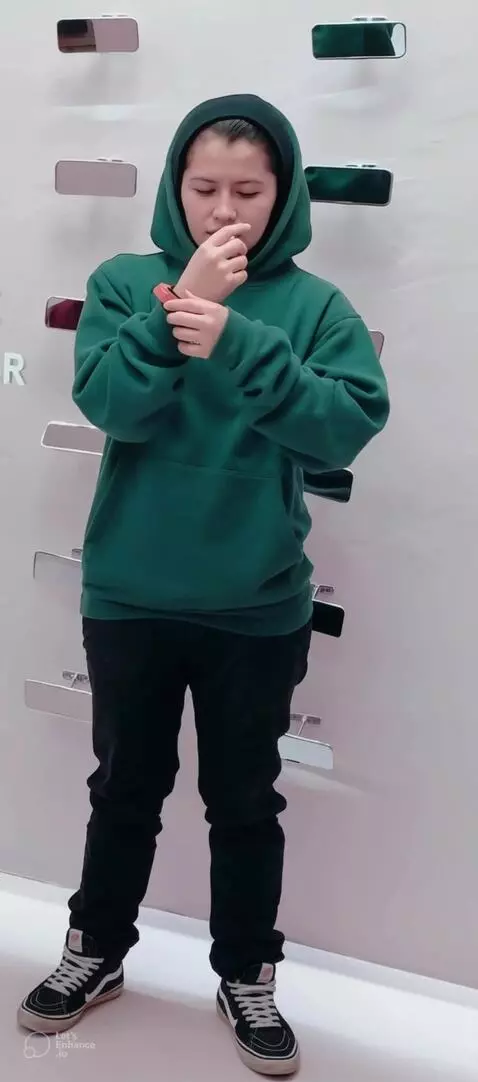 AI Video from prompt: She rolls up both of her hoodie sleeves