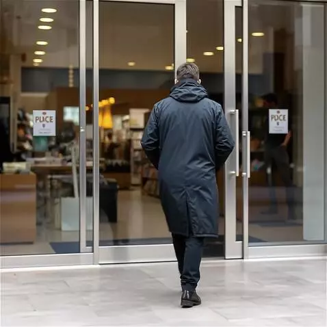 AI Video from prompt: The man turns his back and enters the store. As 