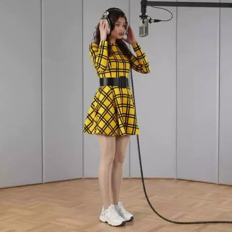 AI Video from prompt: A woman with headphones is singing.  He presses 