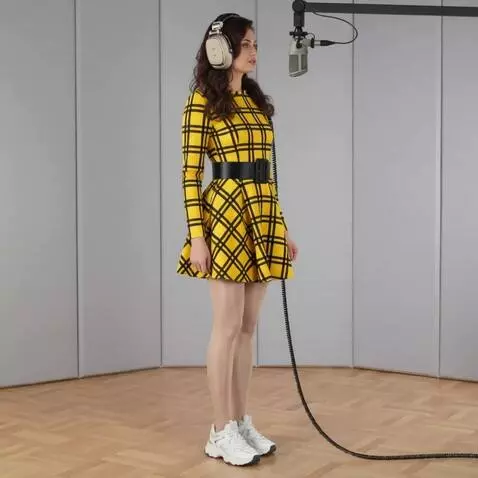 AI Video from prompt: A young woman in a recording studio. Listening t