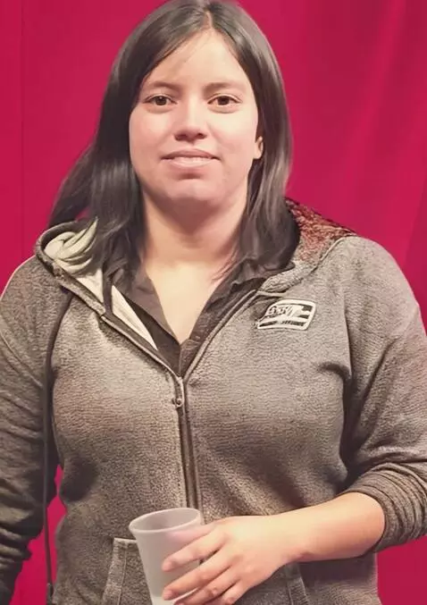 AI Video from prompt: rolling both hoodie sleeves up to reveal her arm