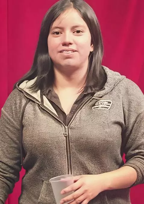 AI Video from prompt: The woman rolling both hoodie sleeves up to reve