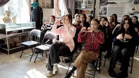 AI Video from prompt: the girls are fans, they show hearts with their 
