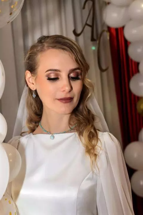 AI Video from prompt: With a serene smile, the blonde bride turns slig