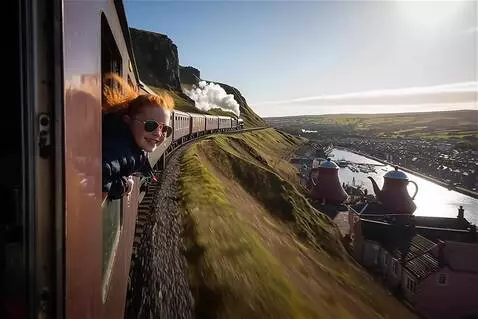 AI Video from prompt: train moving forward. Then the scene changes and