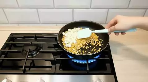 AI Video from prompt: Static camera. A black non-stick frying pan sits
