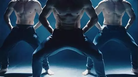 AI Video from prompt: Several shirtless male dancers, shown from the s