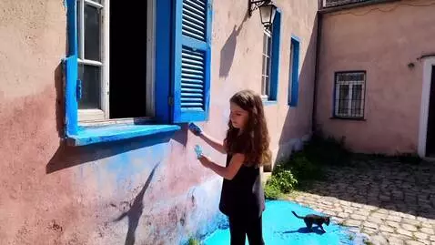 AI Video from prompt: Kyiv, Podil. A girl is painting the shutters of 