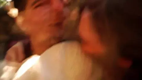 AI Video from prompt: Two friends are hugging on the stairs, laughing 