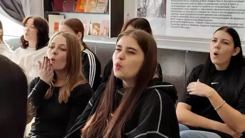 AI Video from prompt: the girls blow kisses and wink, and smile