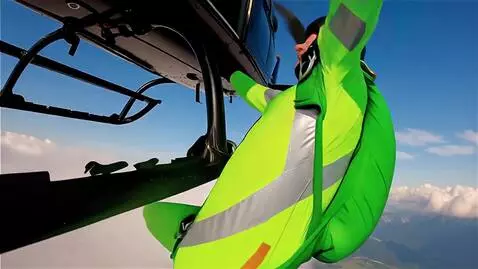 AI Video from prompt: A skydiver in a bright neon jumpsuit and helmet 