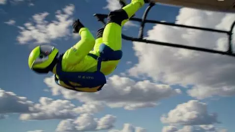 AI Video from prompt: A skydiver in a bright neon jumpsuit and helmet 