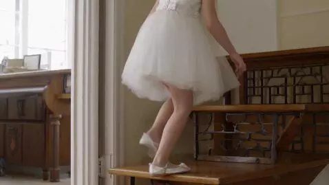 AI Video from prompt: a communion girl wearing a short white dress is 