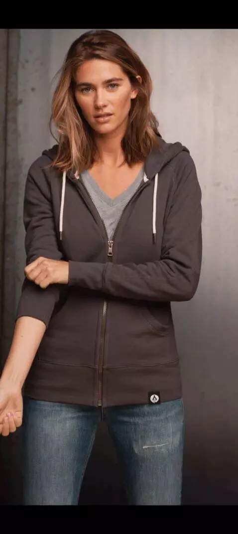 AI Video from prompt: Make her roll both sleeves up smoothly, ending w