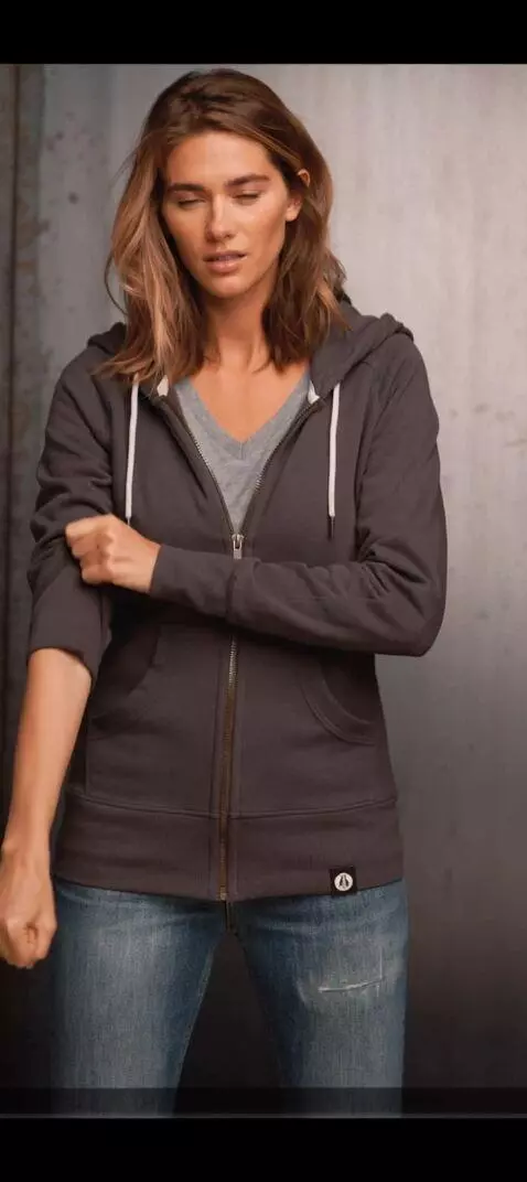 AI Video from prompt: Create motion of her lifting both sleeves up com