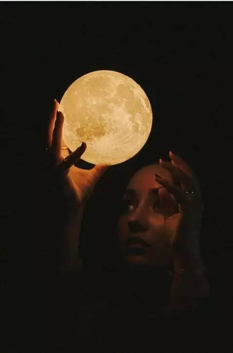 AI Video from prompt: The woman tosses the moon up into the sky reveal