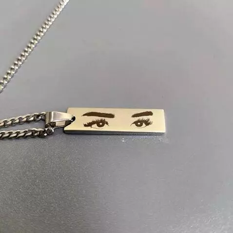 AI Video from prompt: Static close-up shot of a metal pendant lying pe