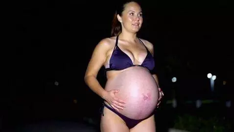 AI Video from prompt: A pregnant woman, who is quite beautiful, goes f