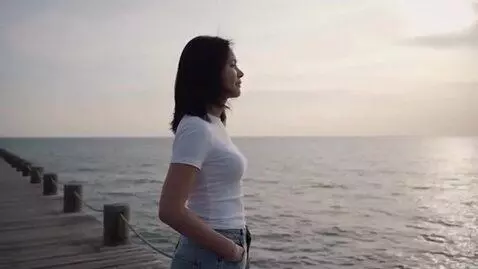 AI Video from prompt: A woman with black hair in a white T-shirt and j