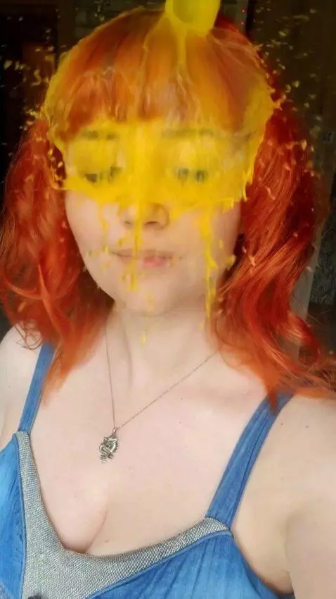 AI Video from prompt: yellow water is pouring on the girl's face
