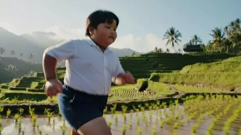 AI Video from prompt: fat kid asian run in the rice field