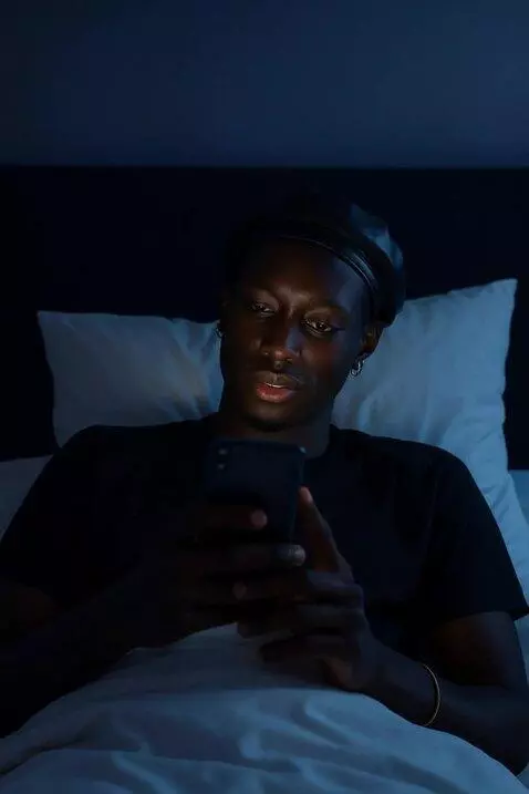 AI Video from prompt: Let him be chatting on his bed with the contrast