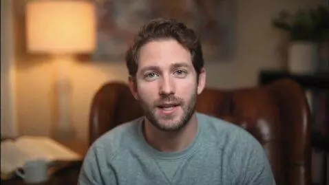 AI Video from prompt: A man in a gray sweatshirt, about thirty years o