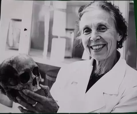 AI Video from prompt: smiles, looks directly at camera, waves her hand