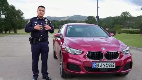 AI Video from prompt: Сделай видео где мент стоит рядом с Матизом вишн