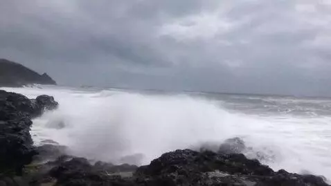 AI Video from prompt: waves crash against the rocks