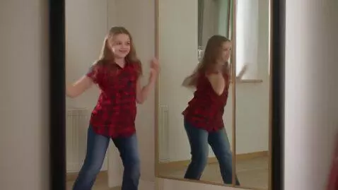 AI Video from prompt: A cute teen girl dancing in the front of mirror 