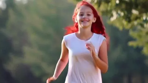 AI Video from prompt: A very beautiful red-haired girl runs towards me