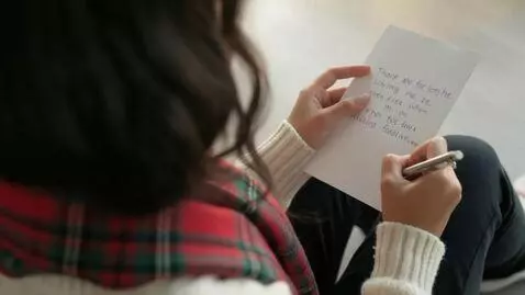 AI Video from prompt: Laura Love is seen writing a handwritten Christm