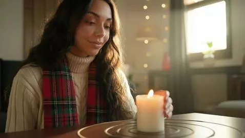 AI Video from prompt: Laura Love is just looking at the at the candle.
