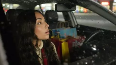 AI Video from prompt: Laura Love is seeing observing from her car wind