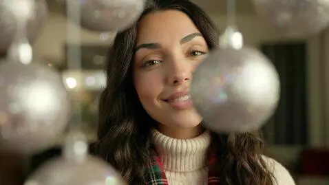 AI Video from prompt: Laura Love is filmed smiling at the camera behin