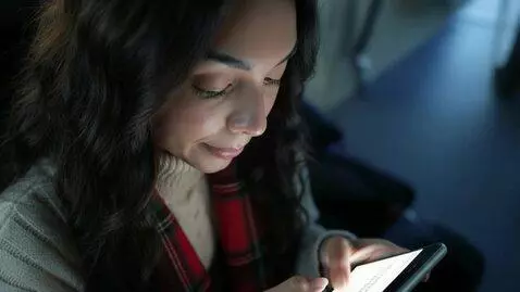 AI Video from prompt: Laura Love is seen looking at her phone hoping t