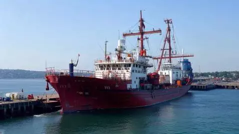 AI Video from prompt: The port of Altınova in Turkey. The Red Rock is 