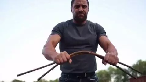 AI Video from prompt: Vertical video for 5 seconds. A man holds an iro