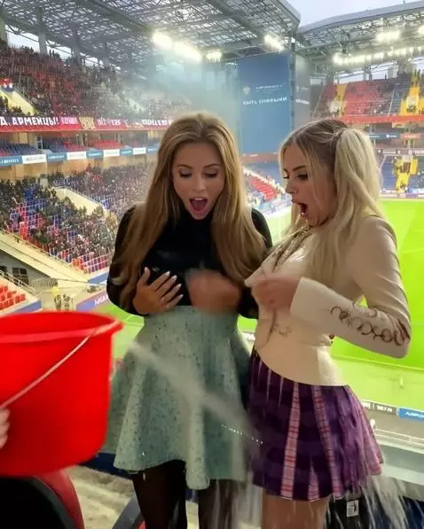 AI Video from prompt: Women are doused with water from a bucket and th