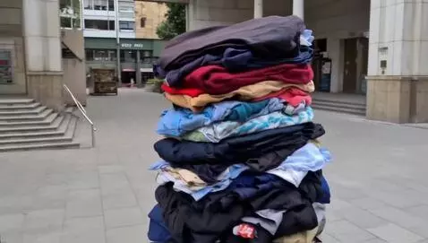 AI Video from prompt: a thin man is wearing the most clothes anyone ha